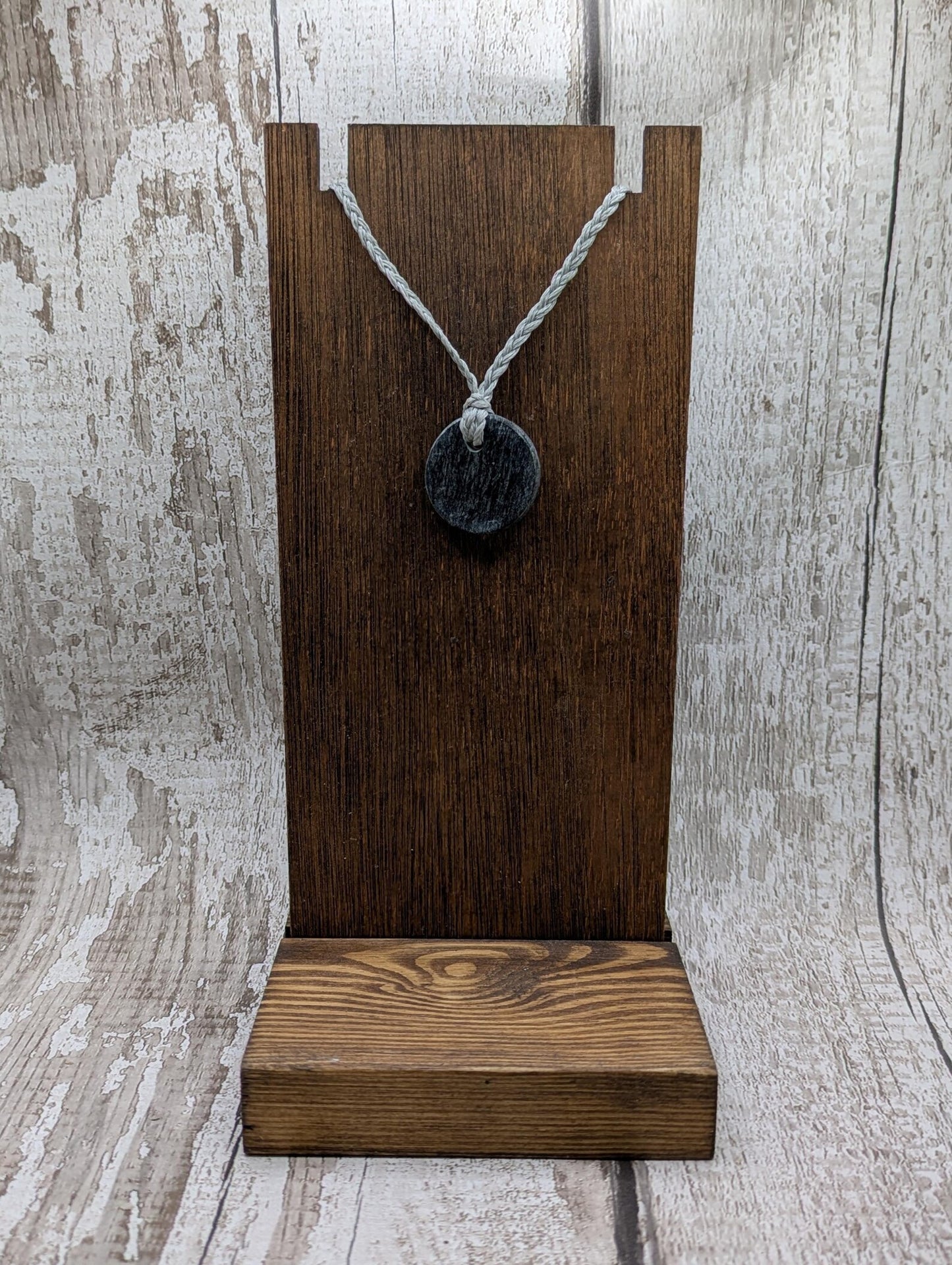 Low grade Shungite asymmetric disc pendants.
