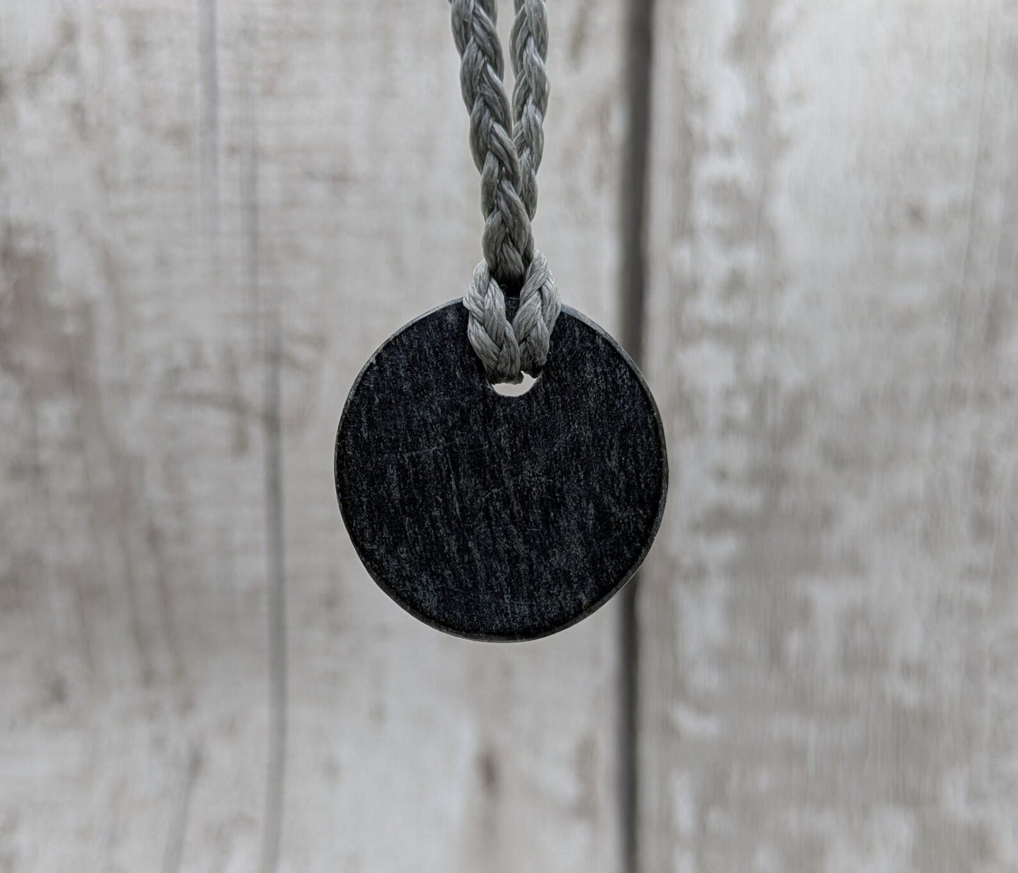 Low grade Shungite asymmetric disc pendants.