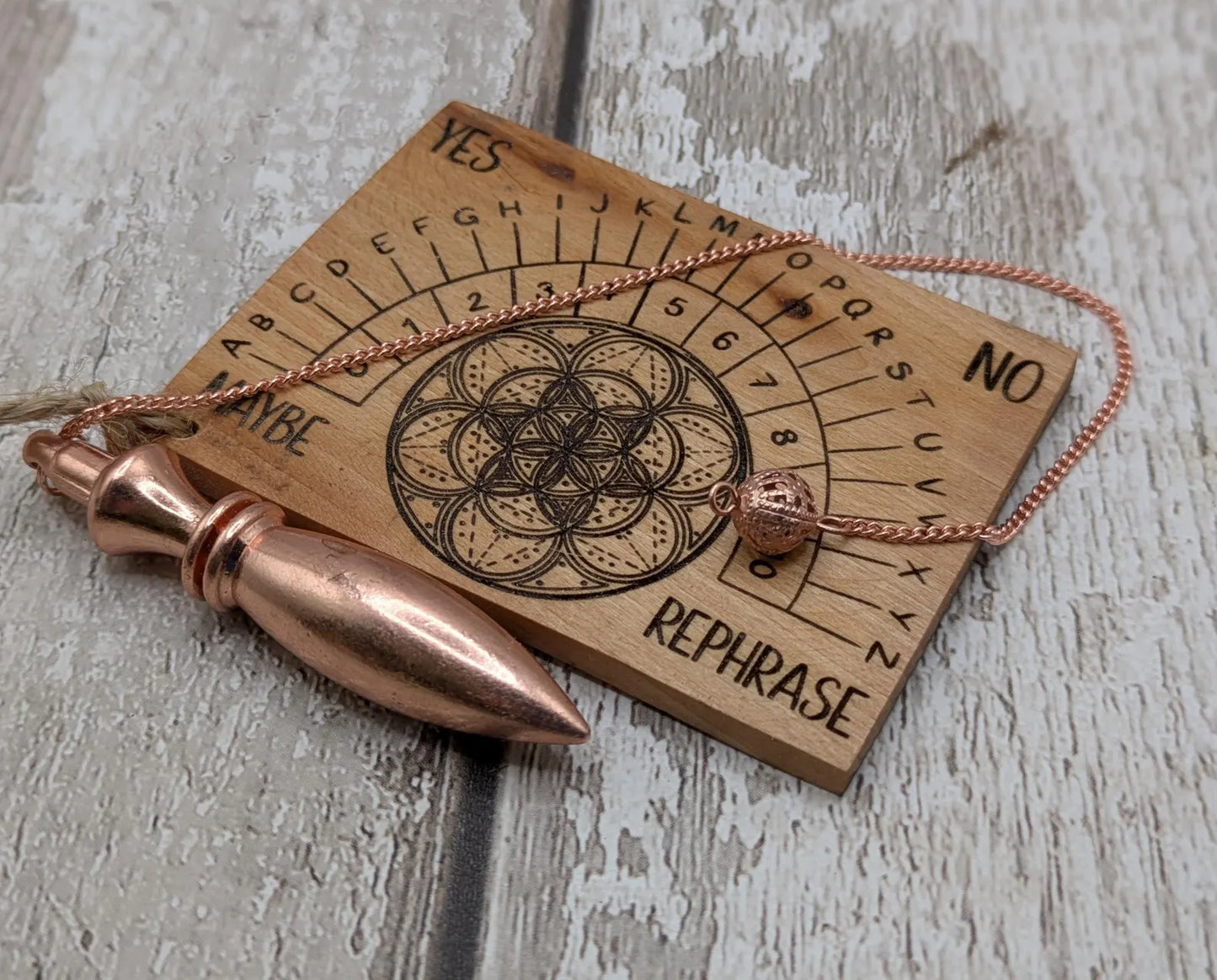 Pocket sized alder wood pendulum dowsing board.