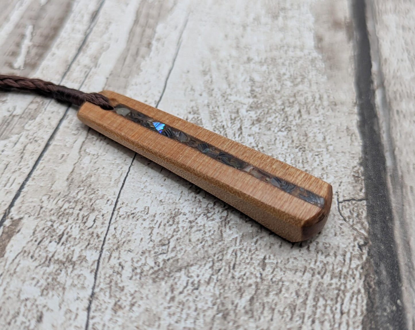 NZ Swamp Kauri wood pendant with rainbow pāua shell.