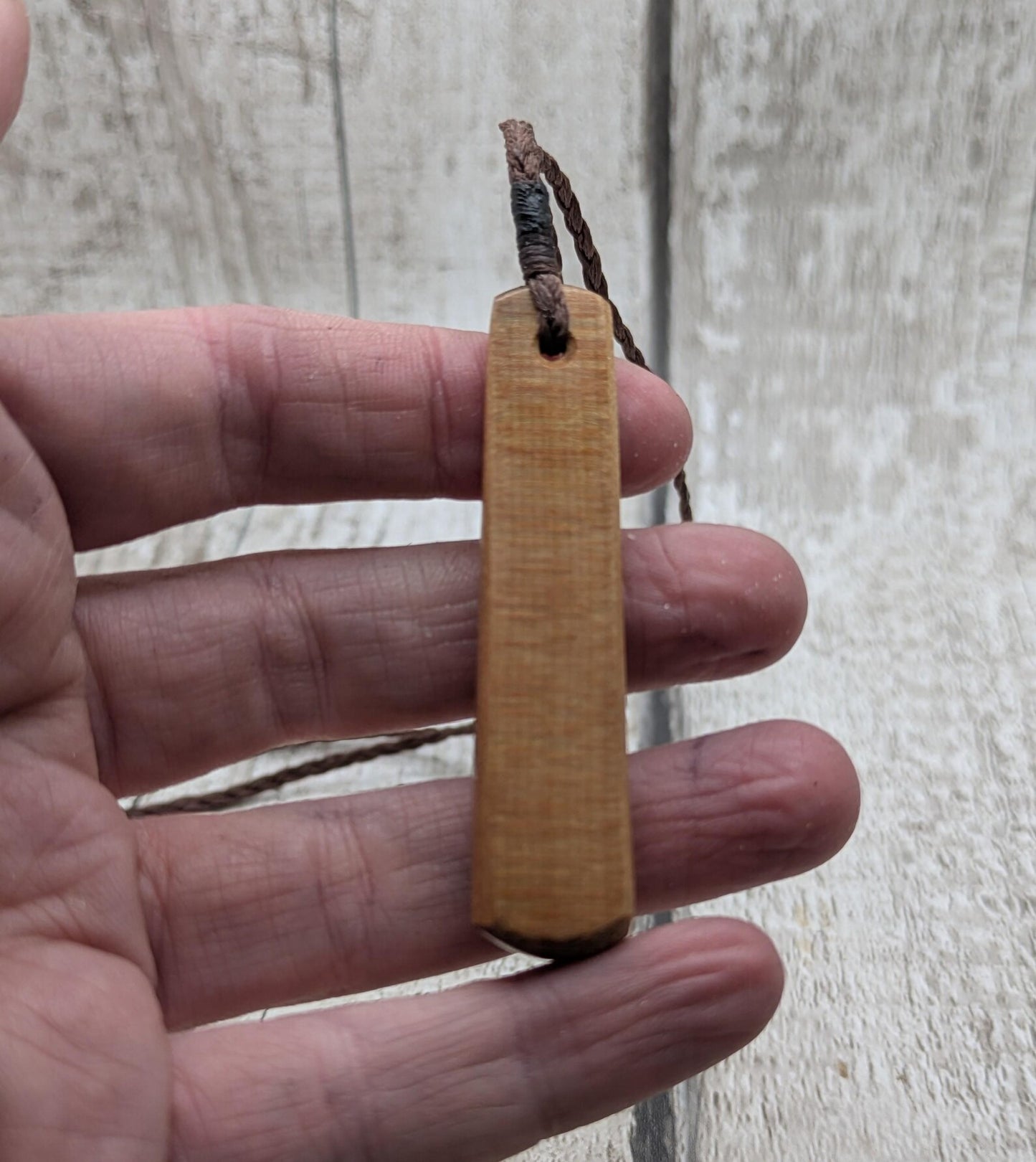 NZ Swamp Kauri wood pendant with rainbow pāua shell.
