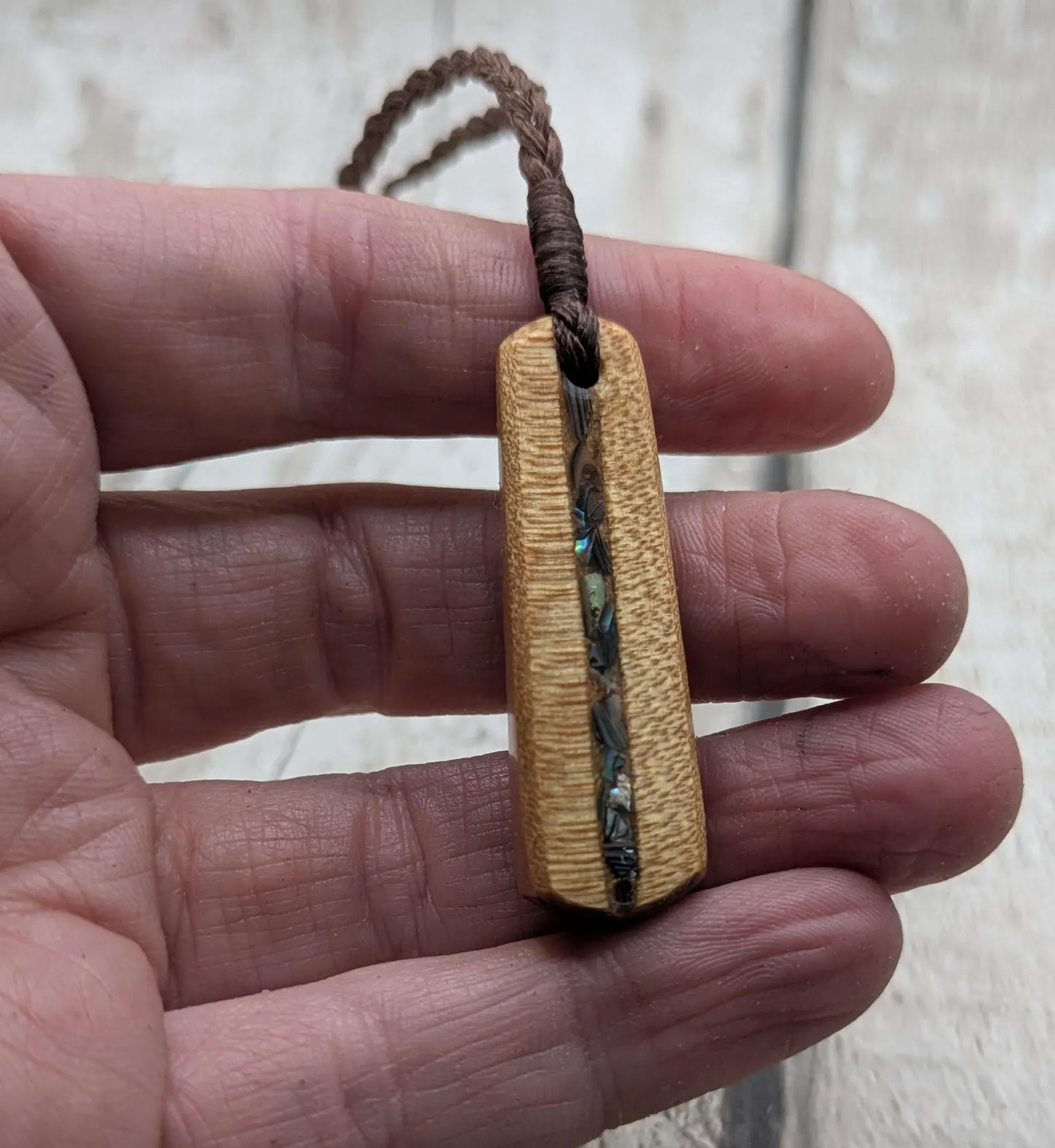 New Zealand swamp kauri roimata pendant with rainbow Pāua.