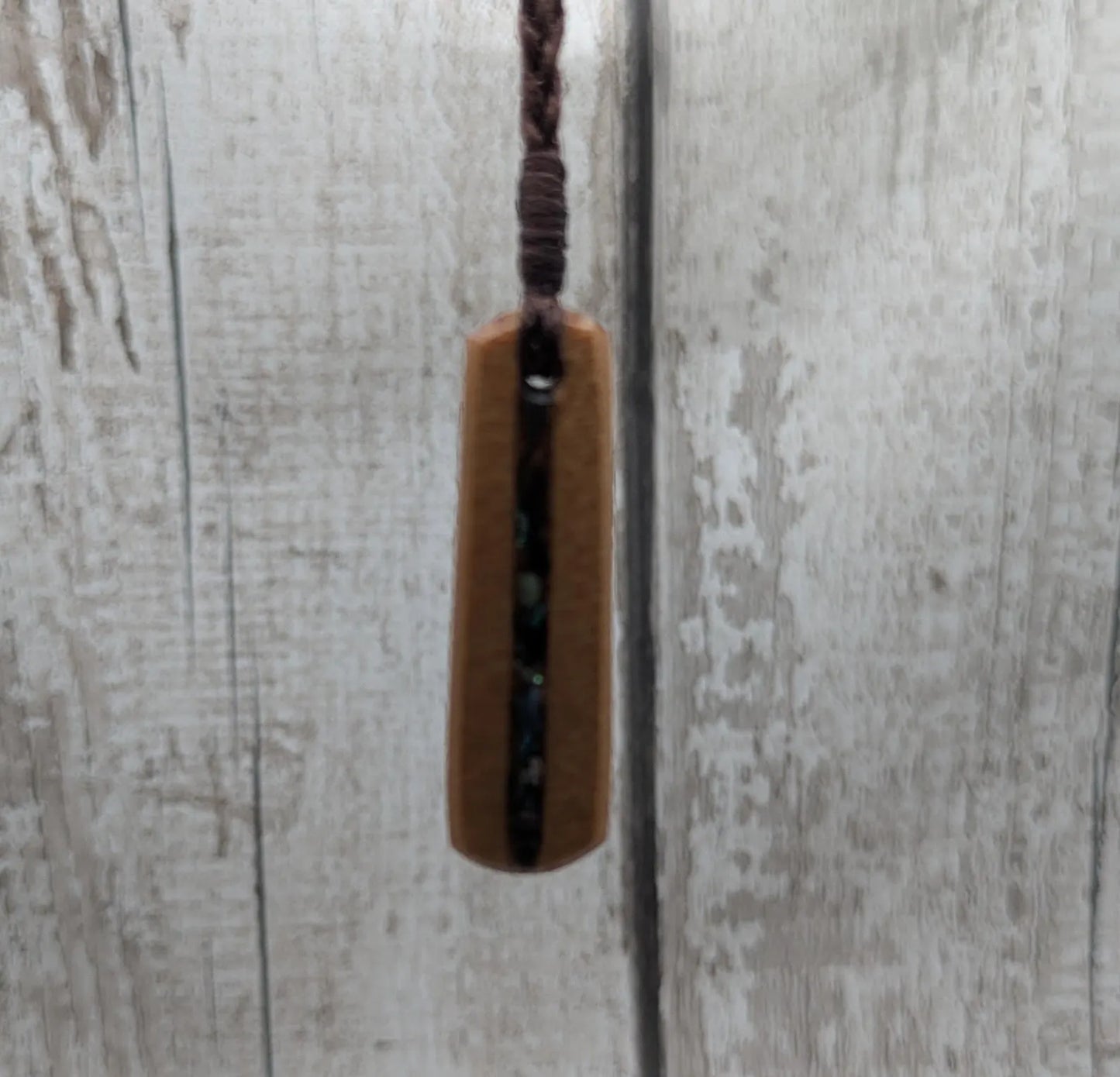 New Zealand swamp kauri roimata pendant with rainbow Pāua.