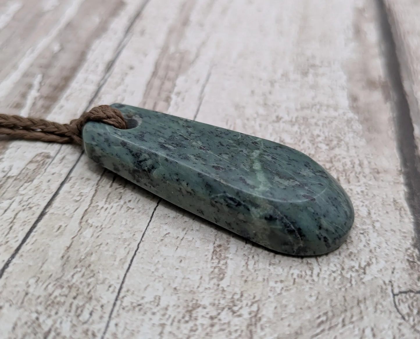 New Zealand Pounamu jade Hei Toki adze styled pendant.