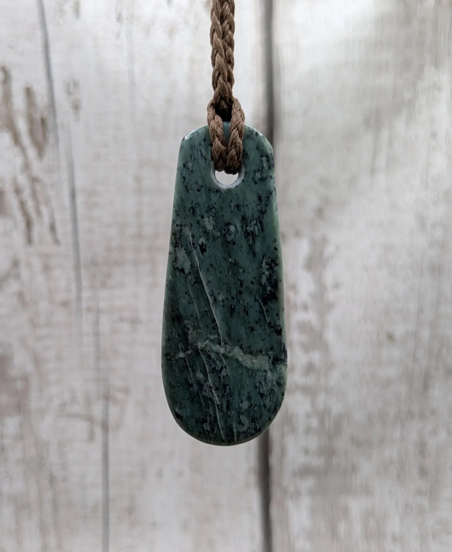 New Zealand Pounamu jade Hei Toki adze styled pendant.