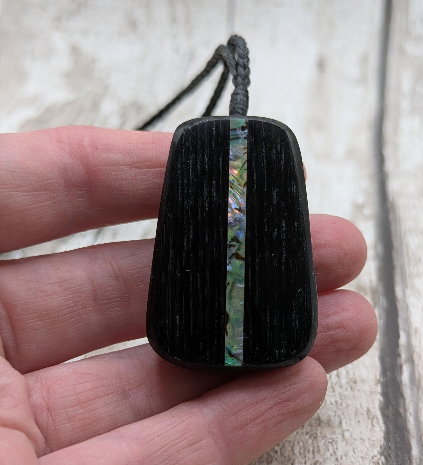 Fenland bog pendant with pāua shell inlay.
