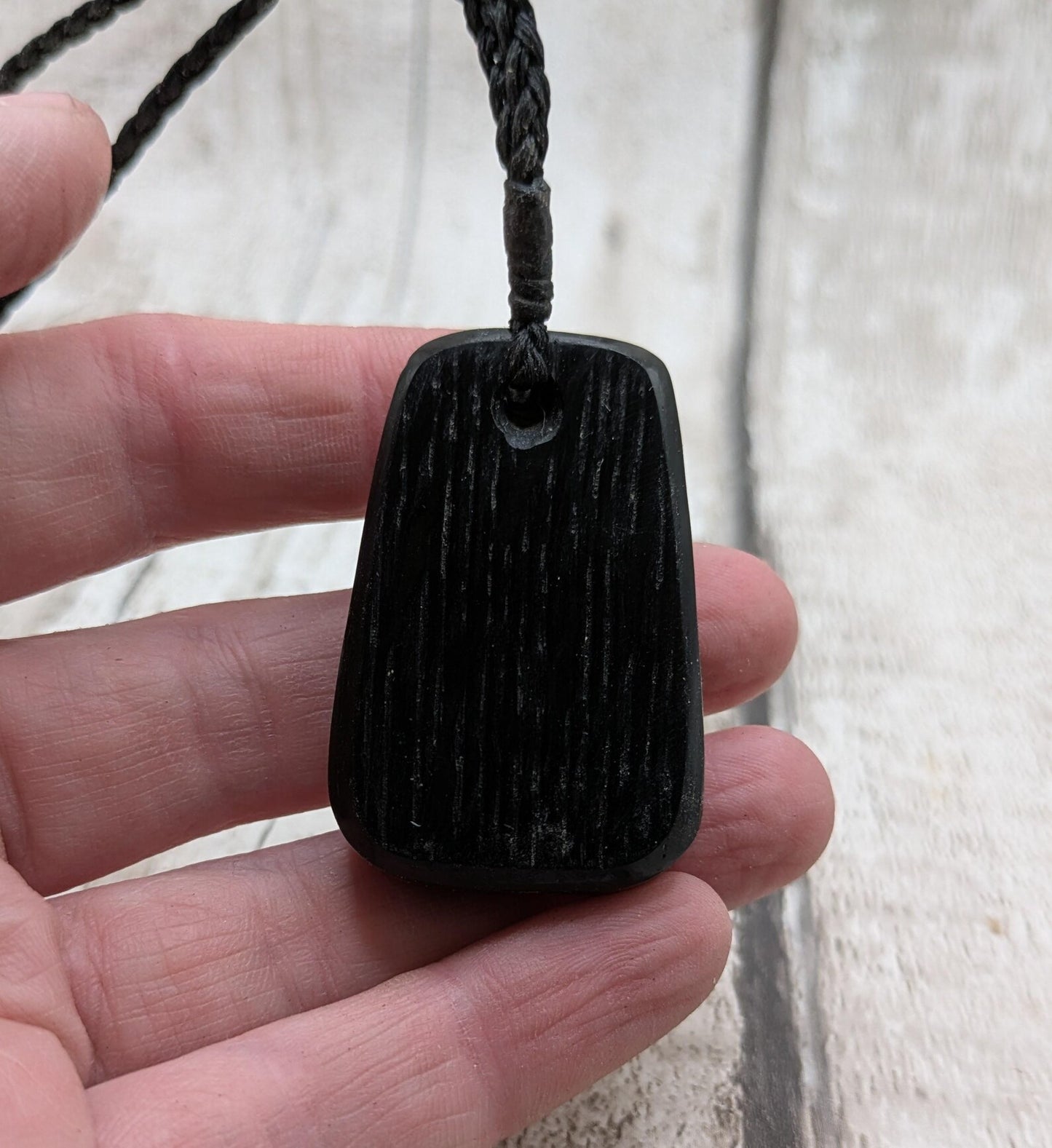 Fenland bog pendant with pāua shell inlay.