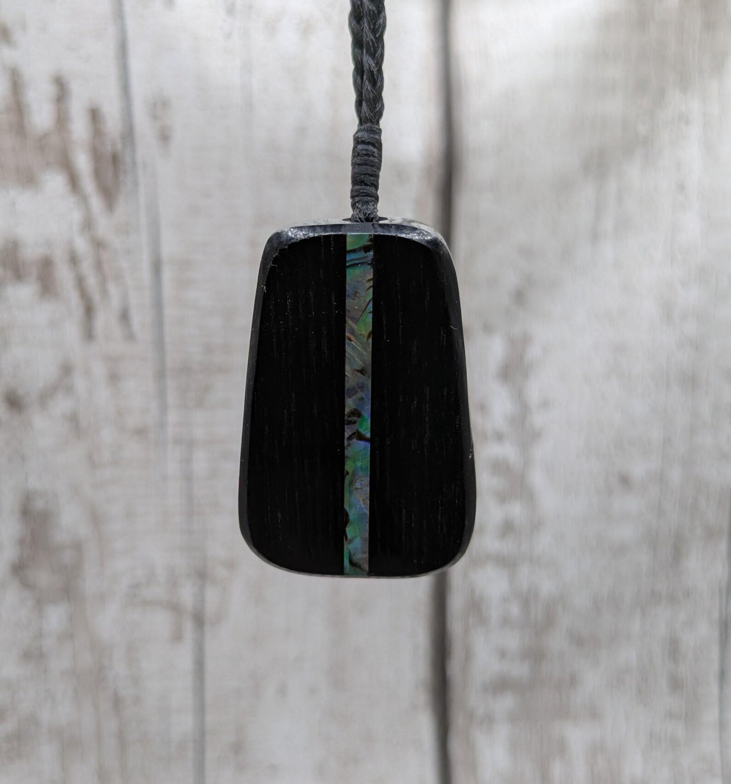 Fenland bog pendant with pāua shell inlay.