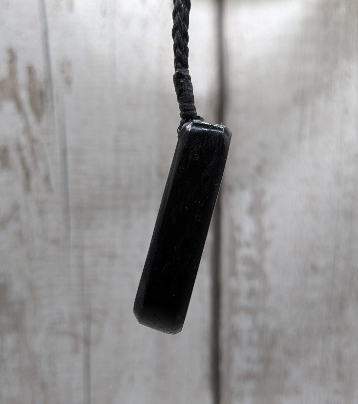 Fenland bog pendant with pāua shell inlay.