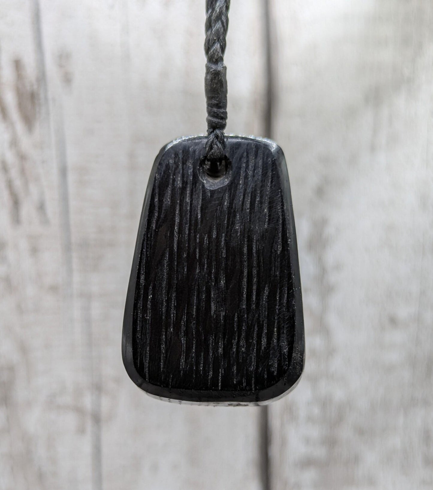 Fenland bog pendant with pāua shell inlay.