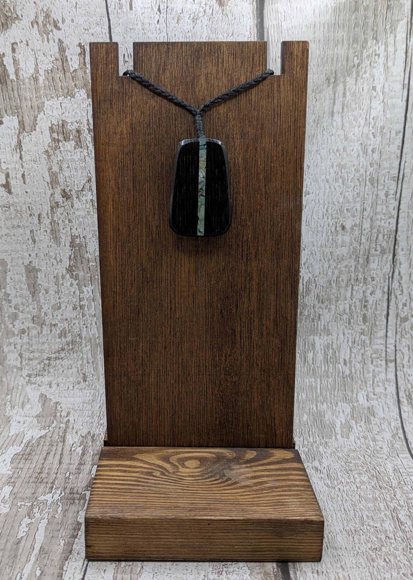 Fenland bog pendant with pāua shell inlay.