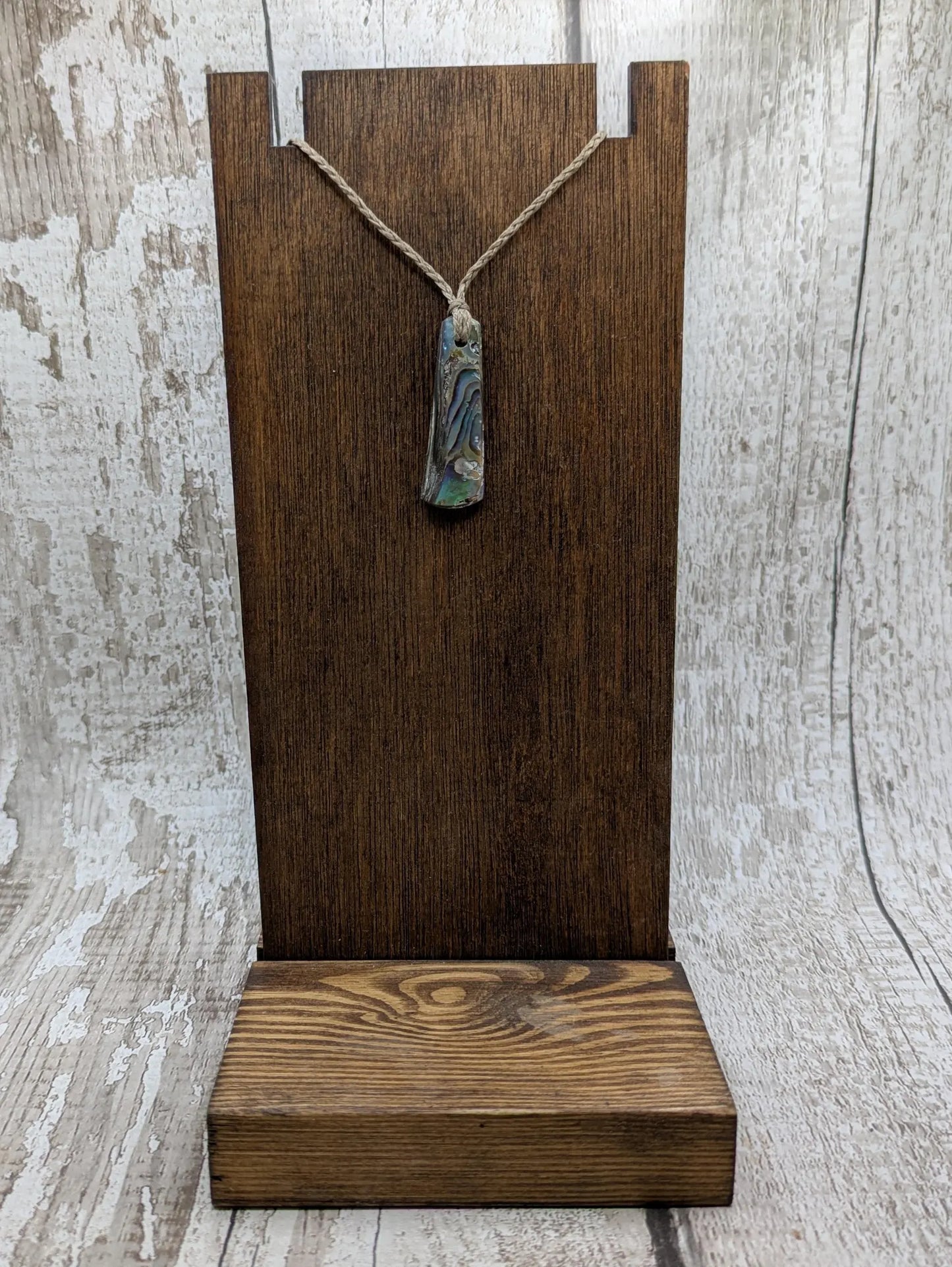 New Zealand rainbow pāua shell pendant on a churn chain.