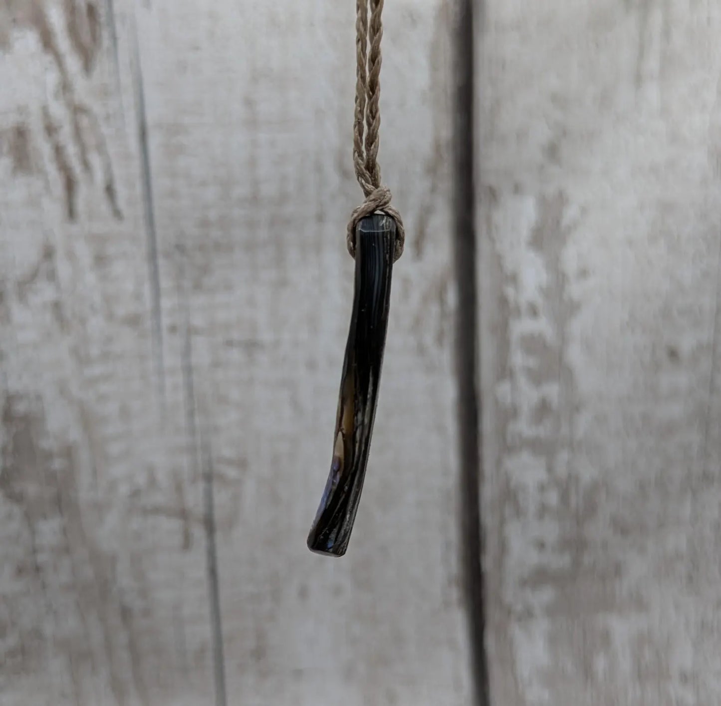 New Zealand rainbow pāua shell pendant on a churn chain.