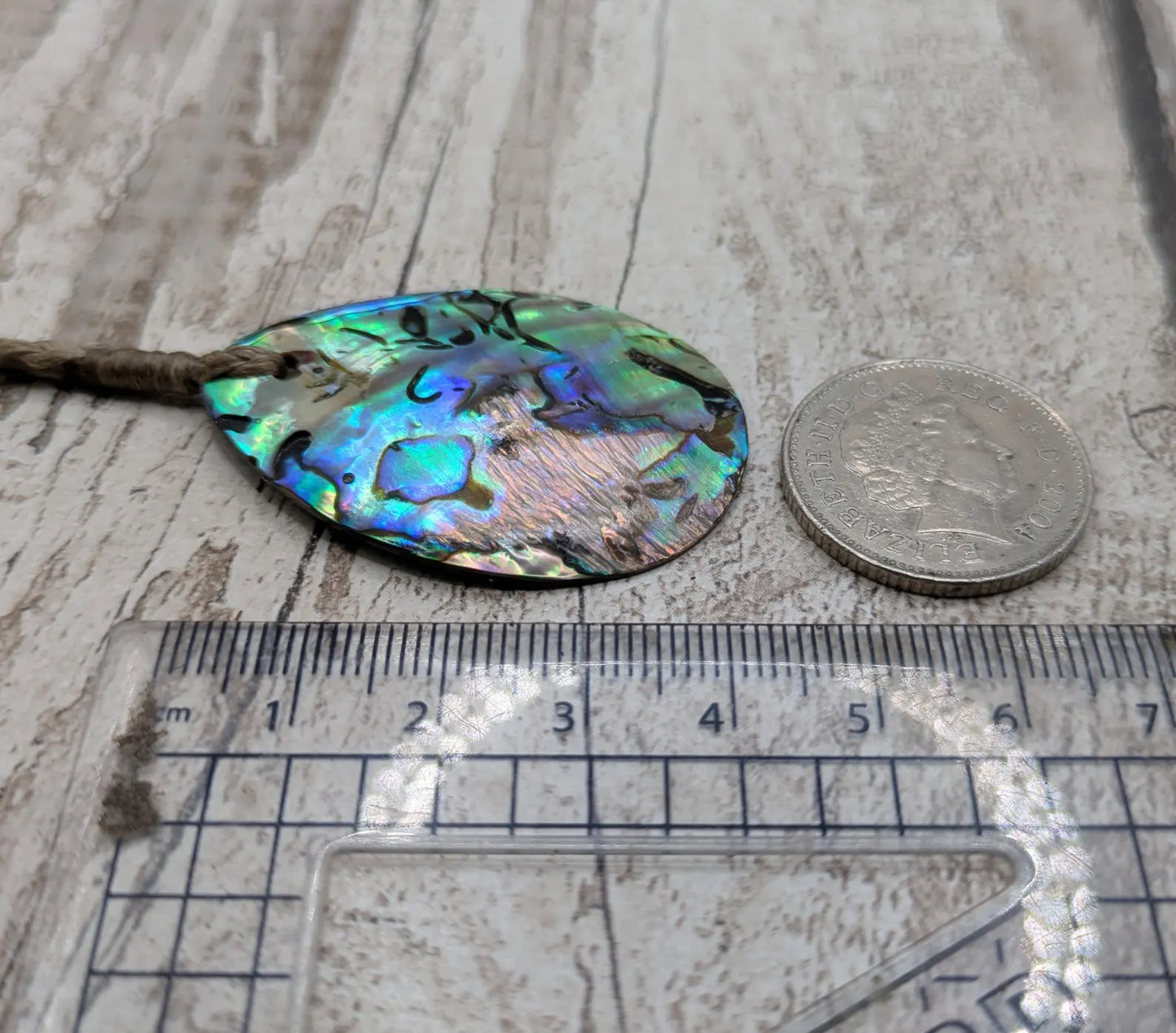 Carved NZ Pāua Shell Oval Pendant – Handcrafted Rainbow Abalone Jewel, Ocean-Inspired fashion, iridescent amulet.