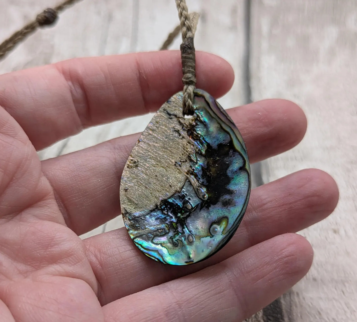 Carved NZ Pāua Shell Oval Pendant – Handcrafted Rainbow Abalone Jewel, Ocean-Inspired fashion, iridescent amulet.