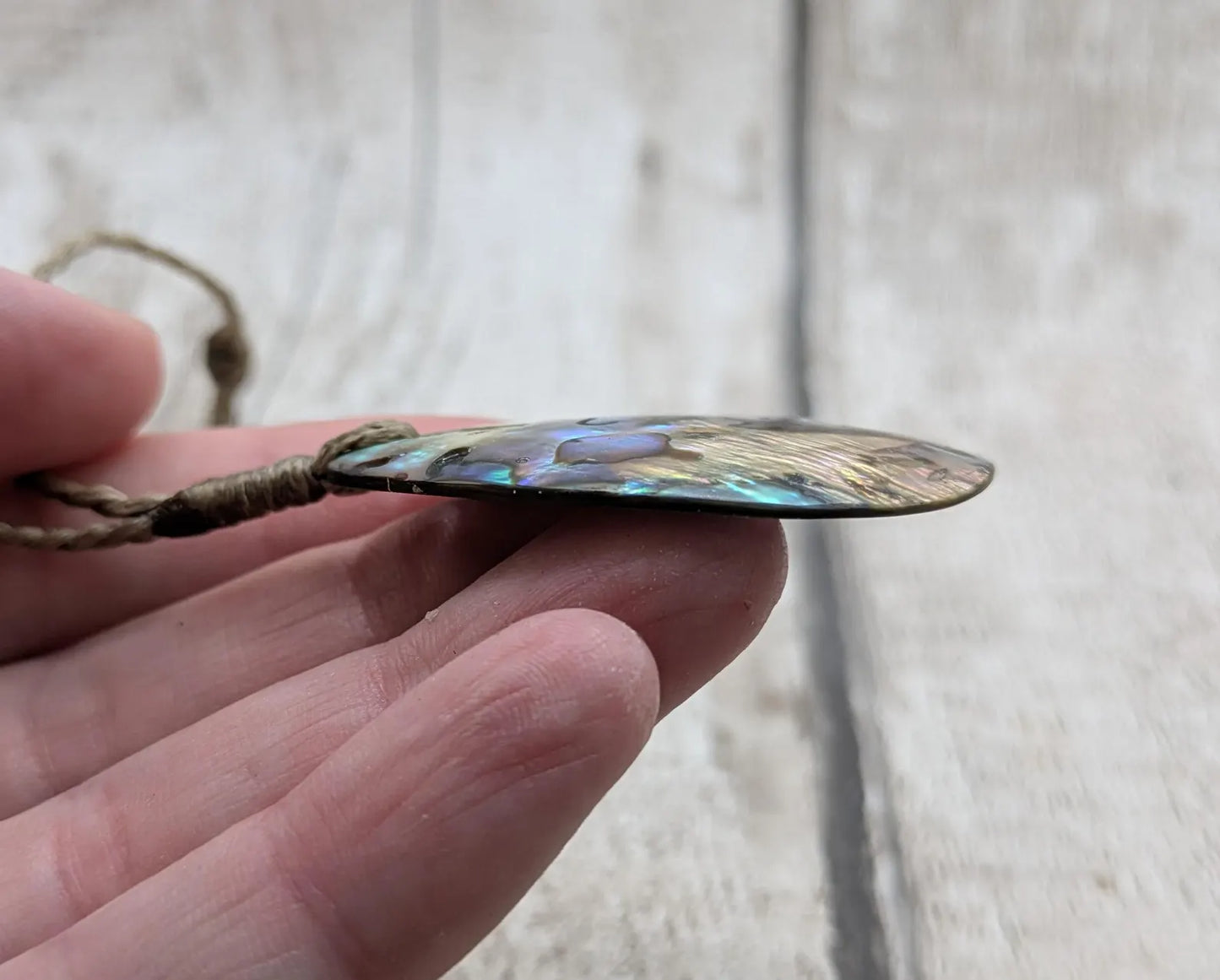 Carved NZ Pāua Shell Oval Pendant – Handcrafted Rainbow Abalone Jewel, Ocean-Inspired fashion, iridescent amulet.
