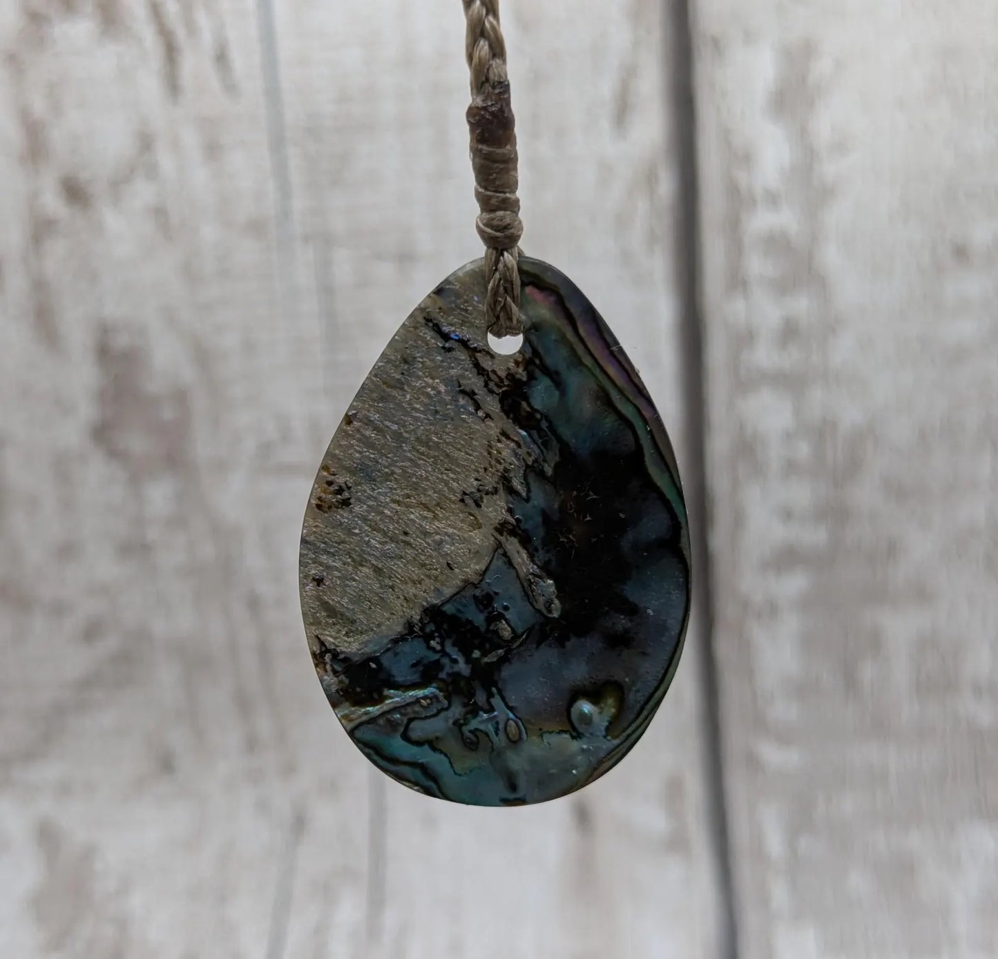Carved NZ Pāua Shell Oval Pendant – Handcrafted Rainbow Abalone Jewel, Ocean-Inspired fashion, iridescent amulet.