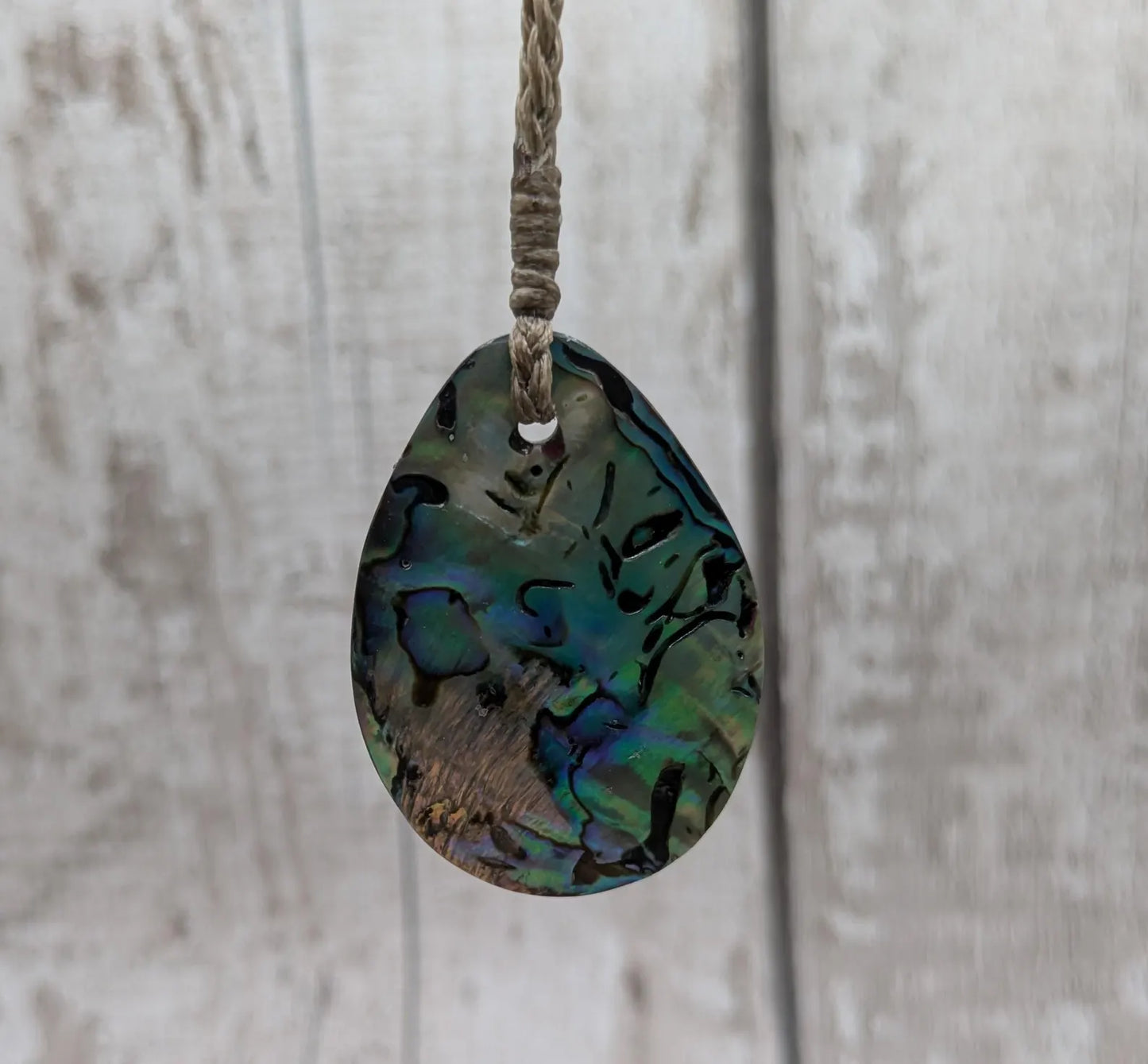 Carved NZ Pāua Shell Oval Pendant – Handcrafted Rainbow Abalone Jewel, Ocean-Inspired fashion, iridescent amulet.