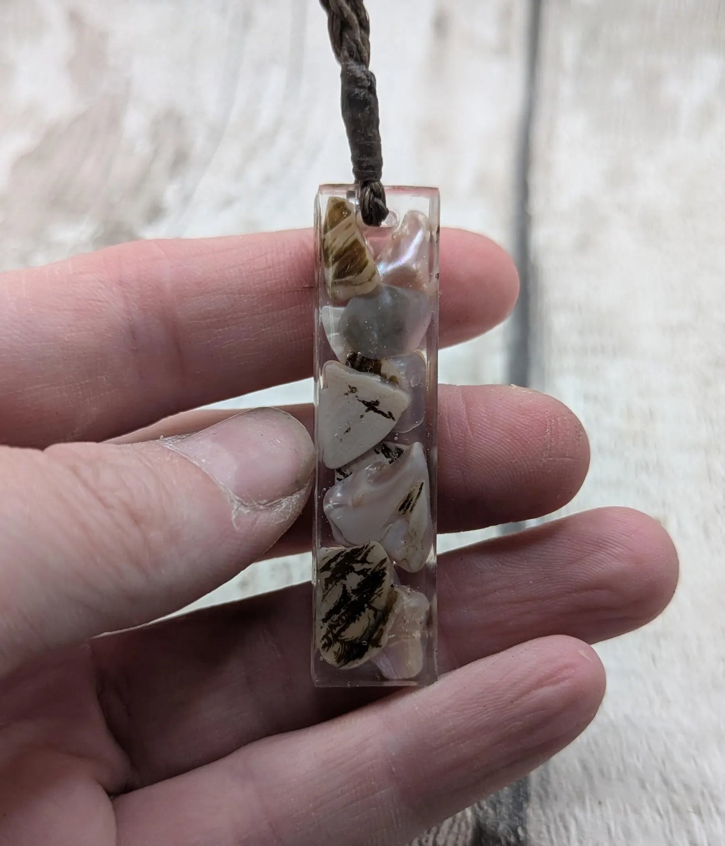 One New Zealand fresh water pink mussel shell in resin.