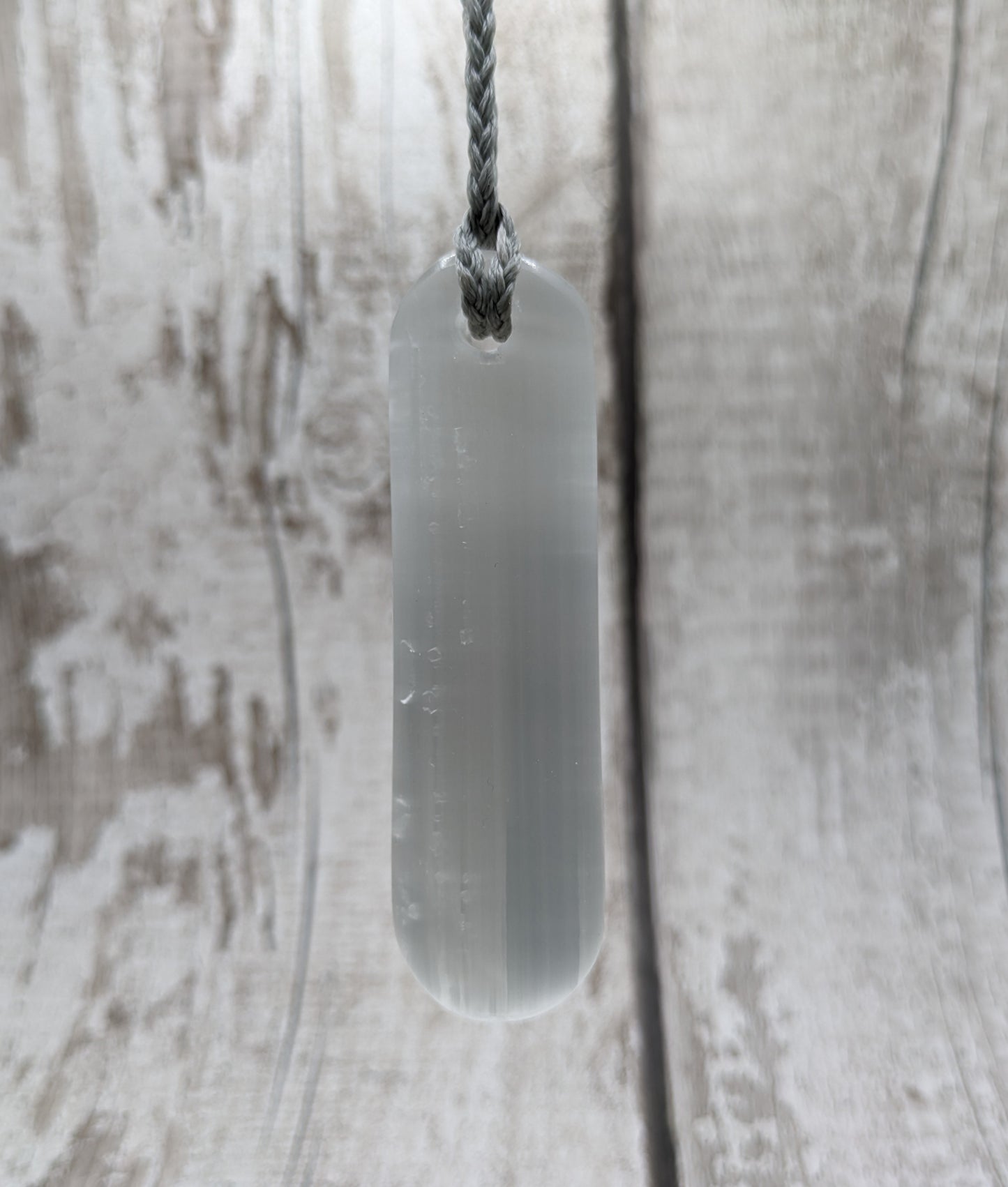 Selenite satin spar toki inspired pendant.