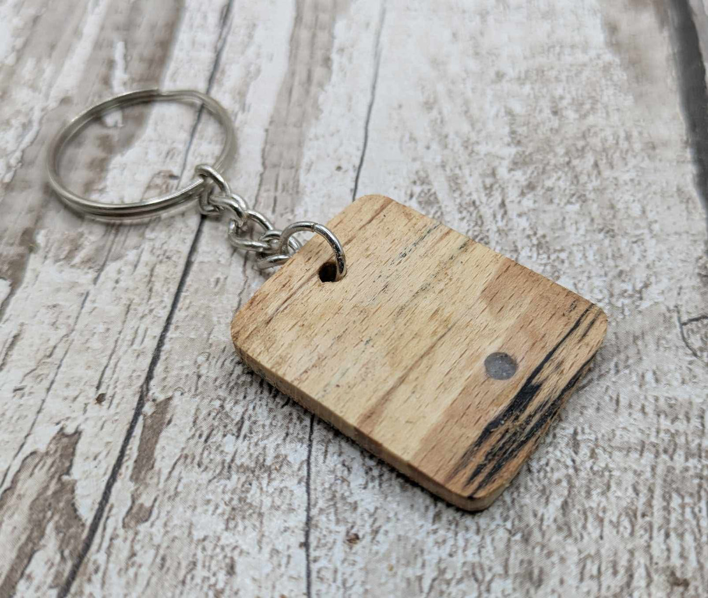 Beech wood keyring with blue kyanite inlay.