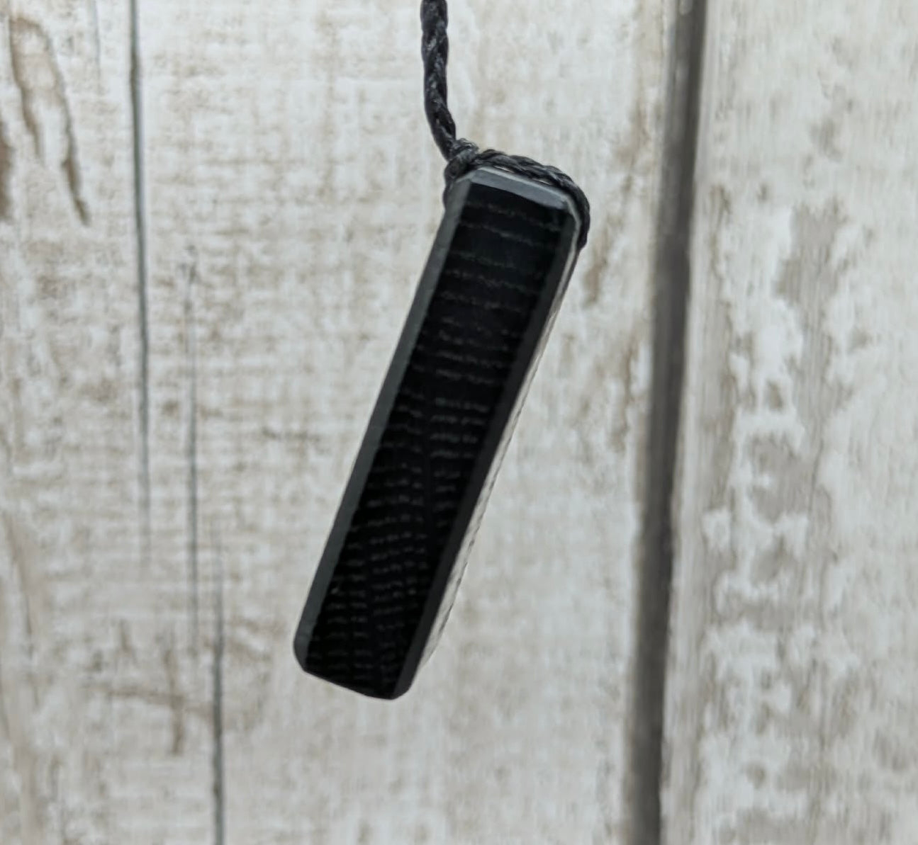 Fenland bog oak rectangular pendant with mammoth tooth inlay.