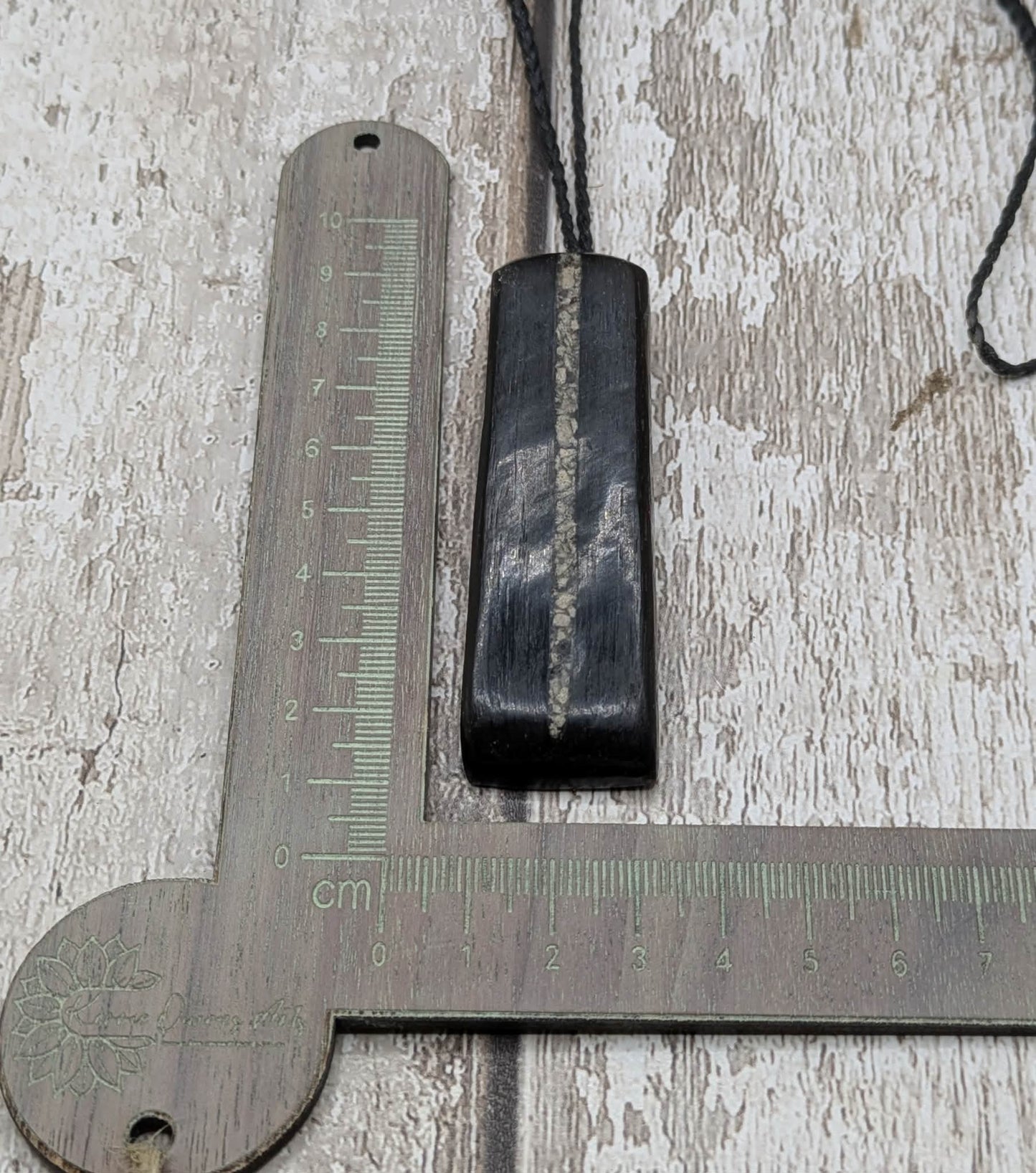 Fenland bog oak pendant with Avebury Sarsen inlay.