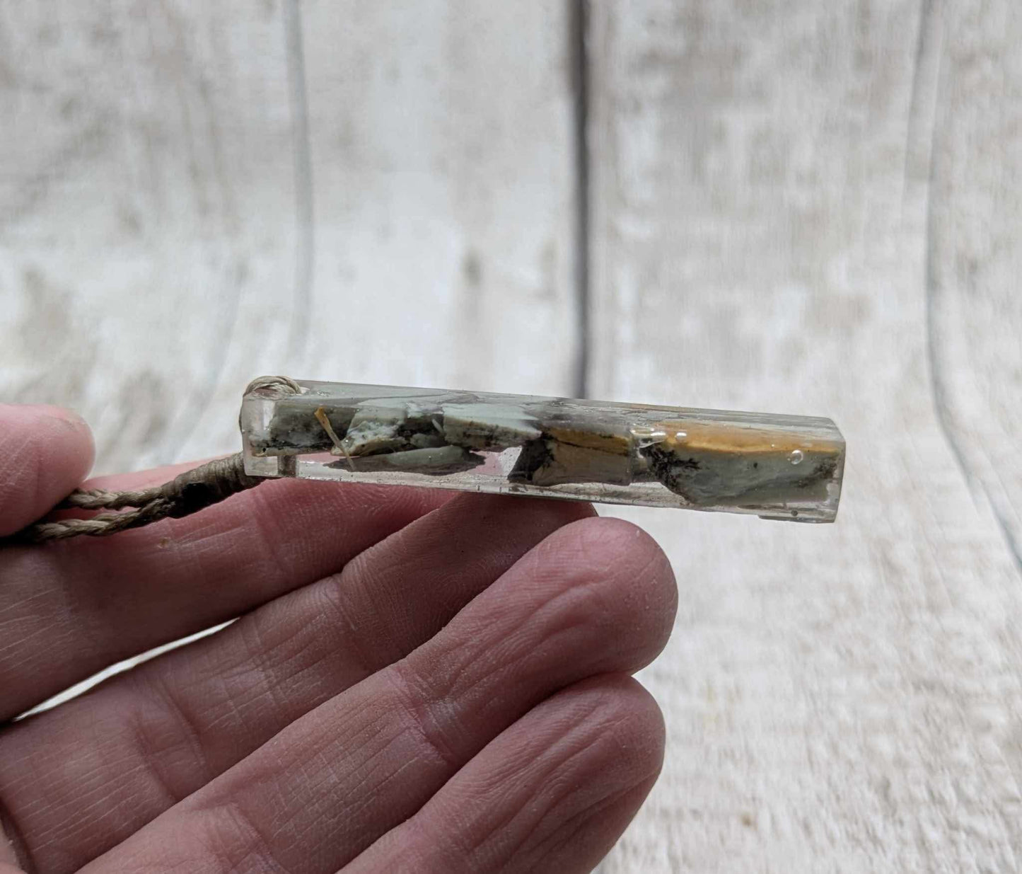New Zealand Pounamu greenstone chip pendant in Uv resin casting.