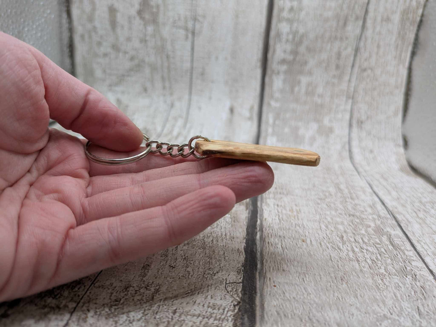 Beech wood keyring with blue kyanite inlay.