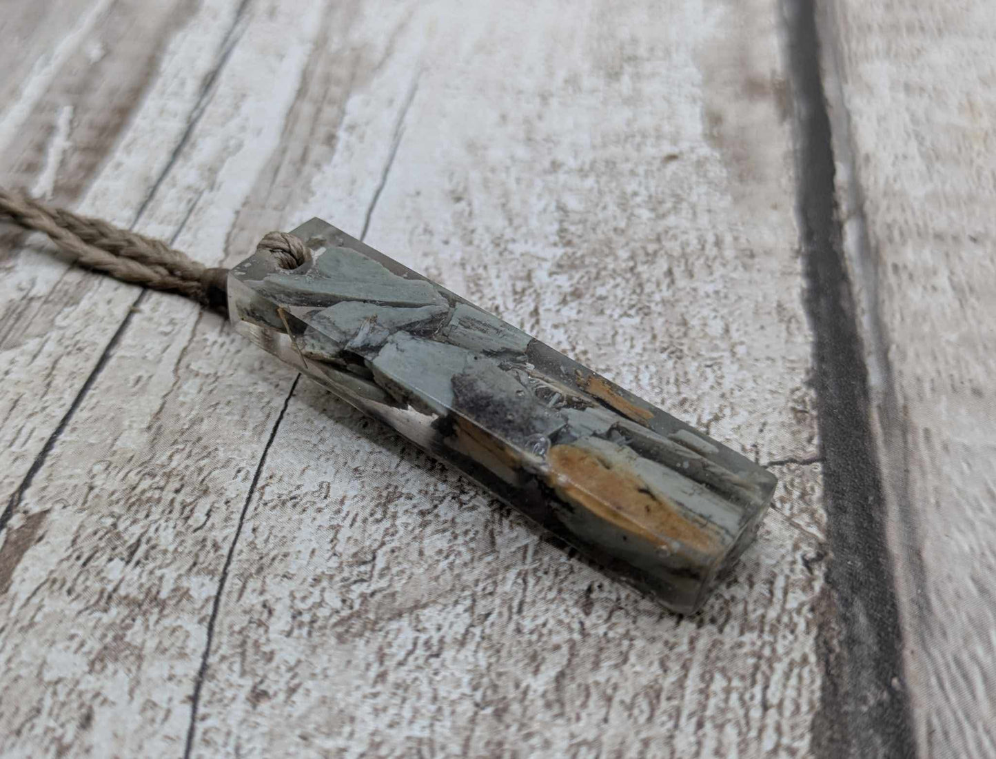 New Zealand Pounamu greenstone chip pendant in Uv resin casting.