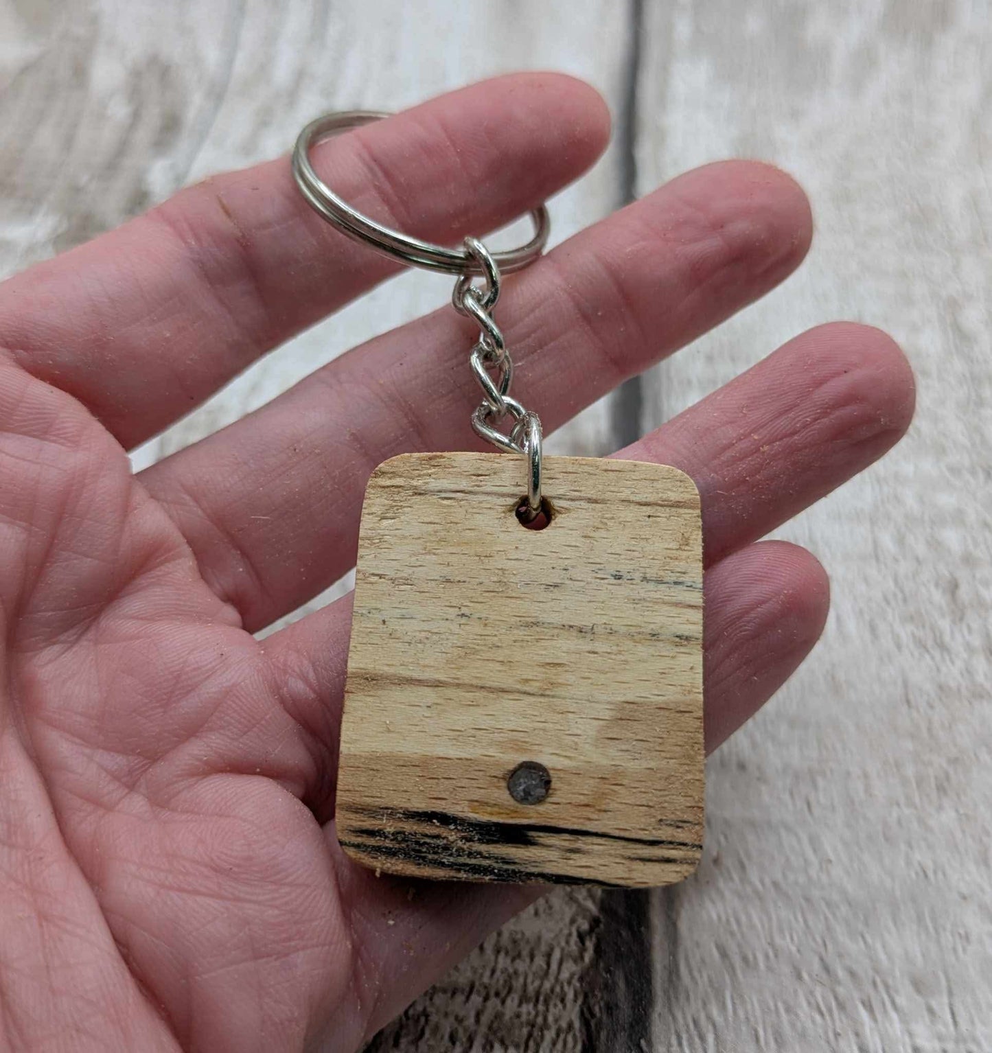 Beech wood keyring with blue kyanite inlay.