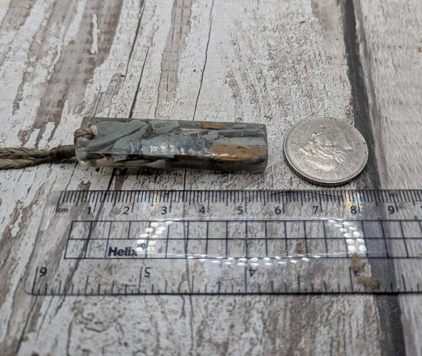 New Zealand Pounamu greenstone chip pendant in Uv resin casting.