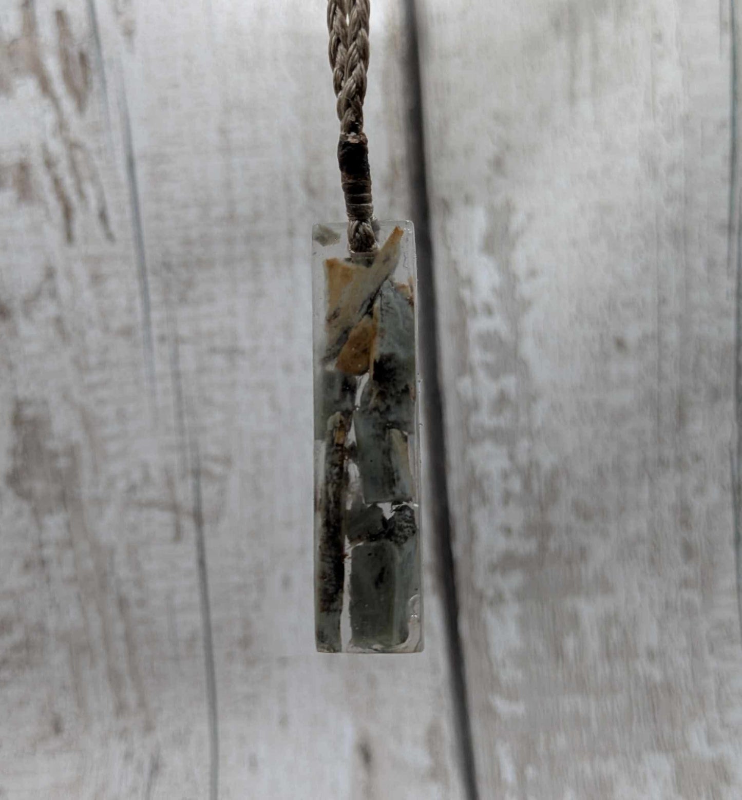 New Zealand Pounamu greenstone chip pendant in Uv resin casting.