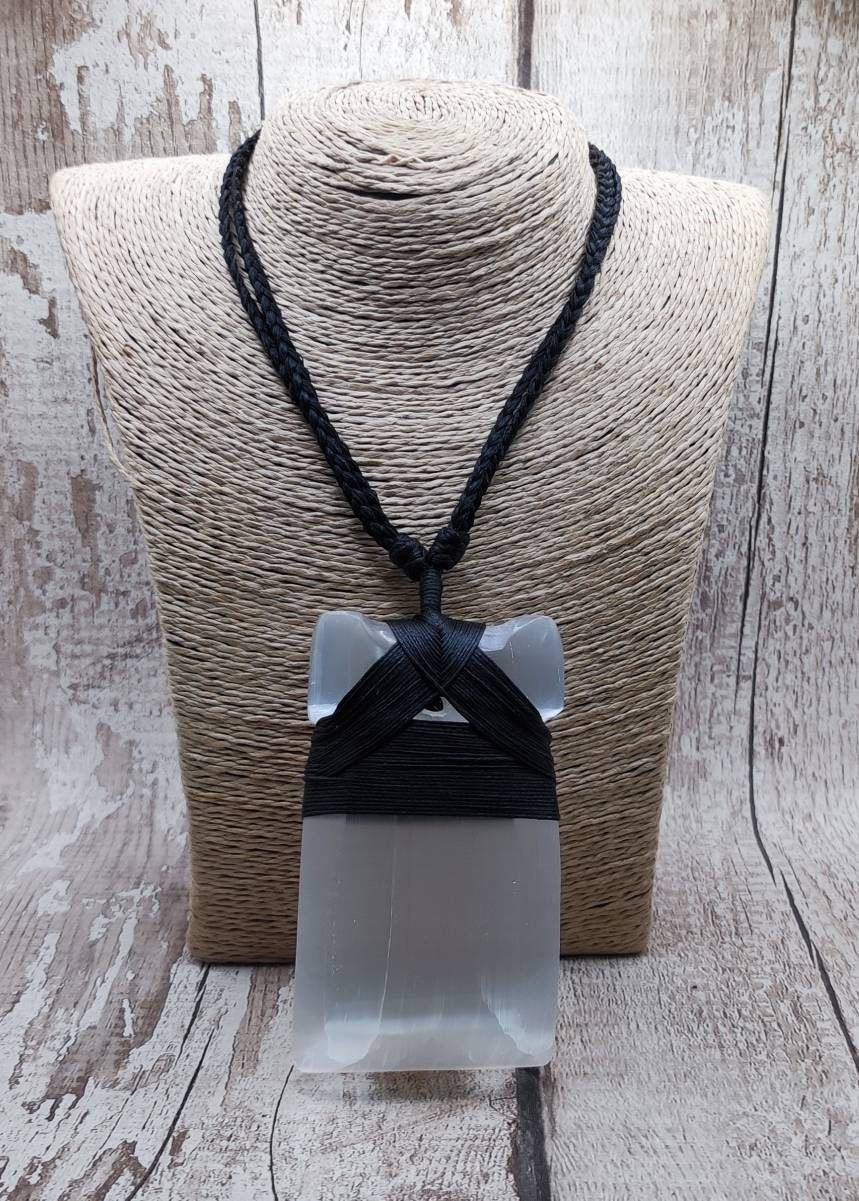 Large selenite hei toki adze carved pendant.