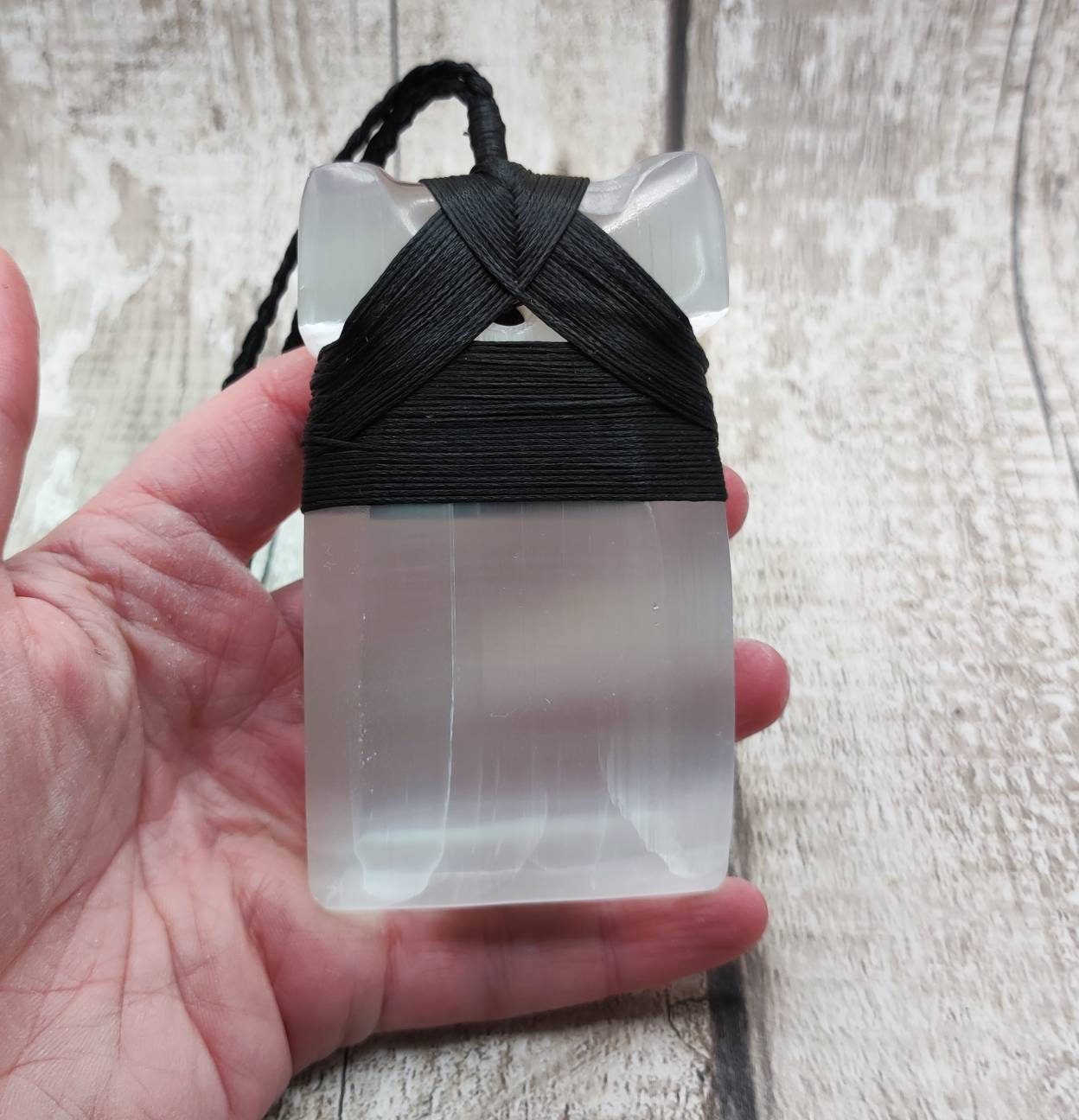 Large selenite hei toki adze carved pendant.