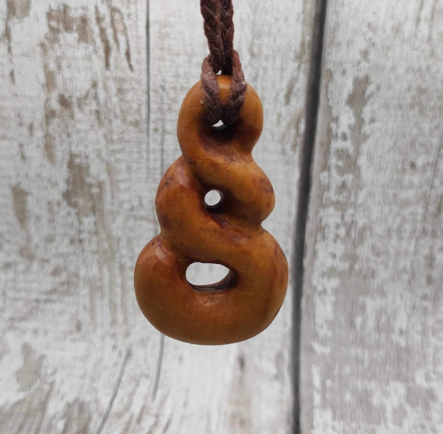 New Zealand Rimu wood pink ours infinity pendant.