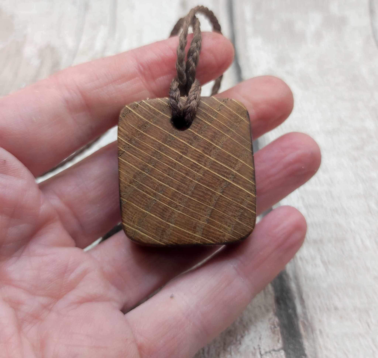 Eihwaz oak wood rune pendant with Pāua shell inlay.