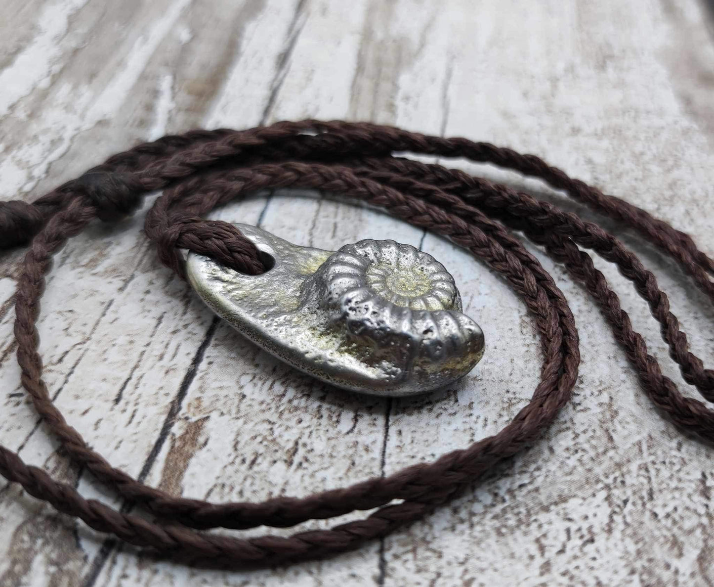 Pewter cast metal ammonite pendant.