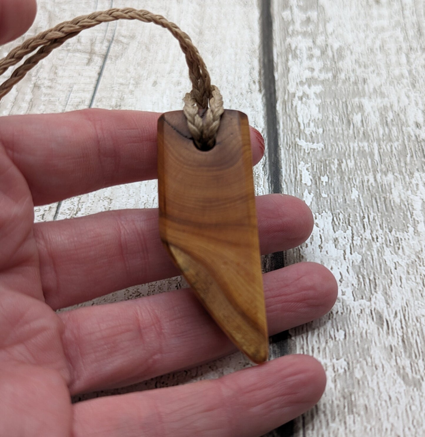 Faceted yew wood slice pendant.