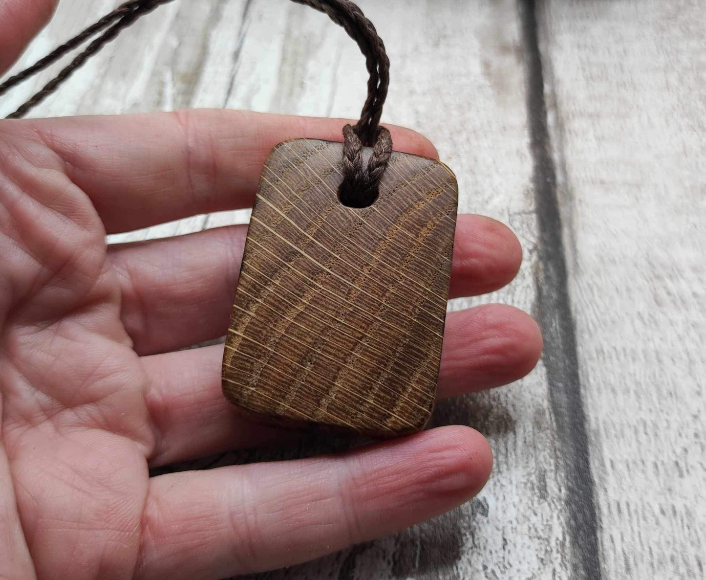 Wunjo oak wood rune pendant with mussel shell inlay.