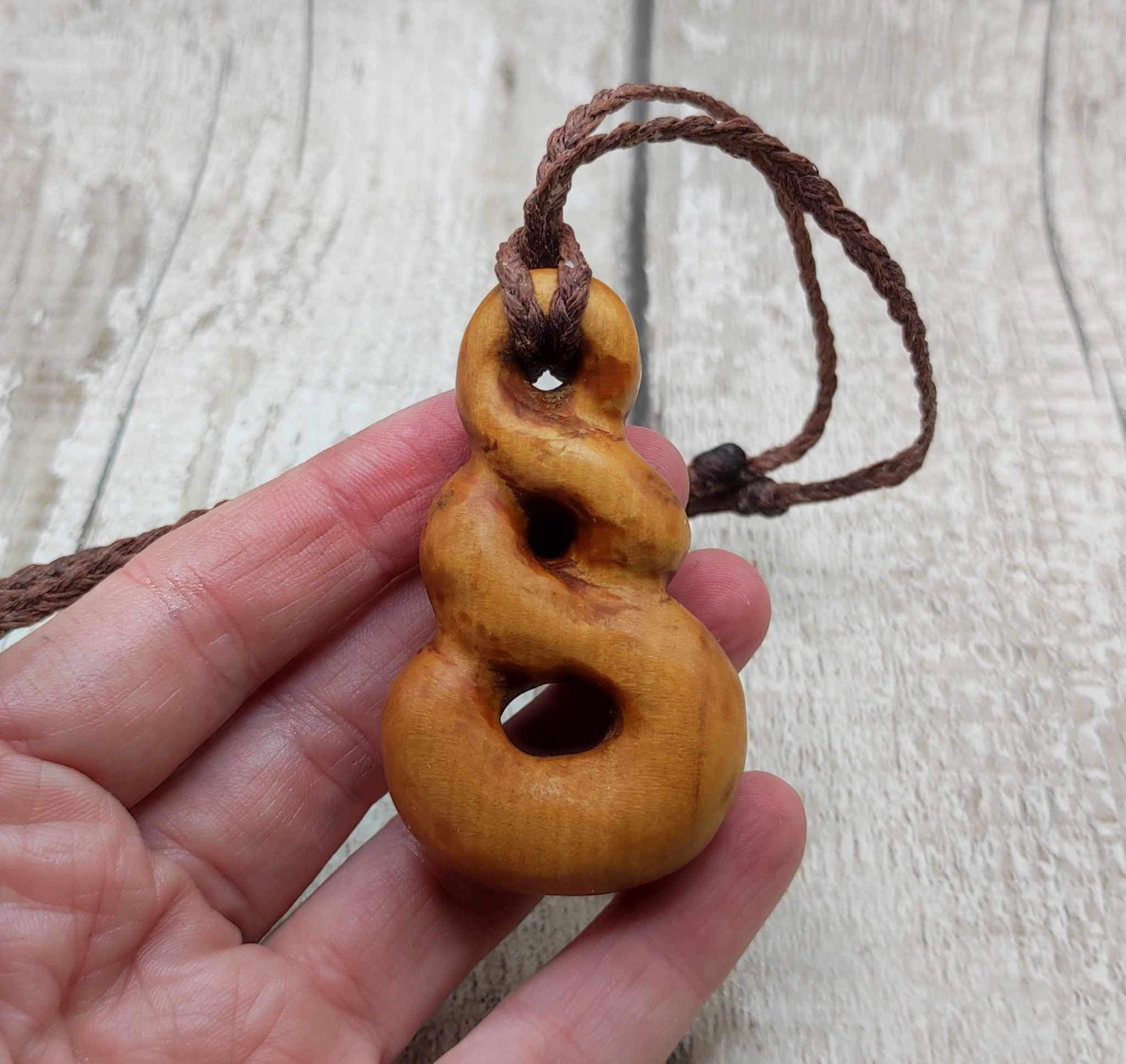 New Zealand Rimu wood pink ours infinity pendant.