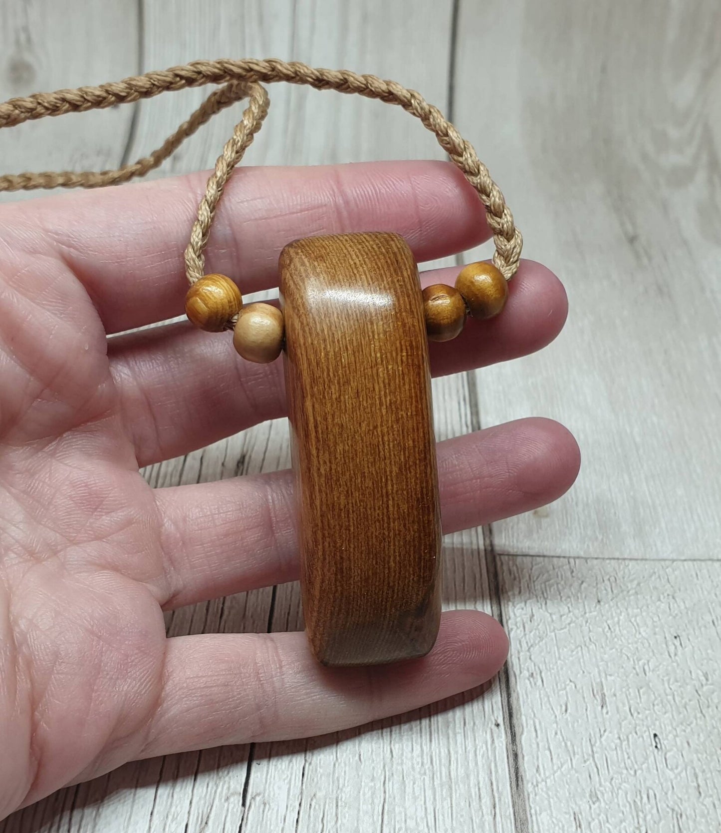 New Zealand Rimu wood adze inspired pendant.