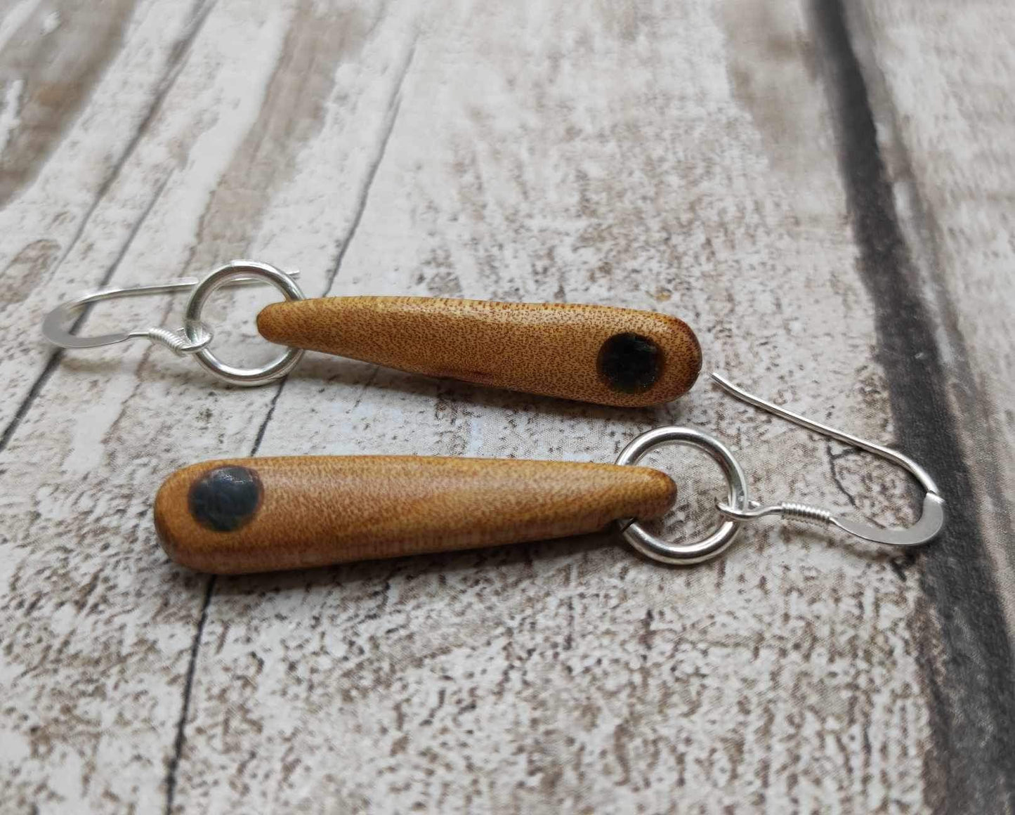 New Zealand swamp kauri wood, roimata earrings, with serpentine Pounamu inlay.