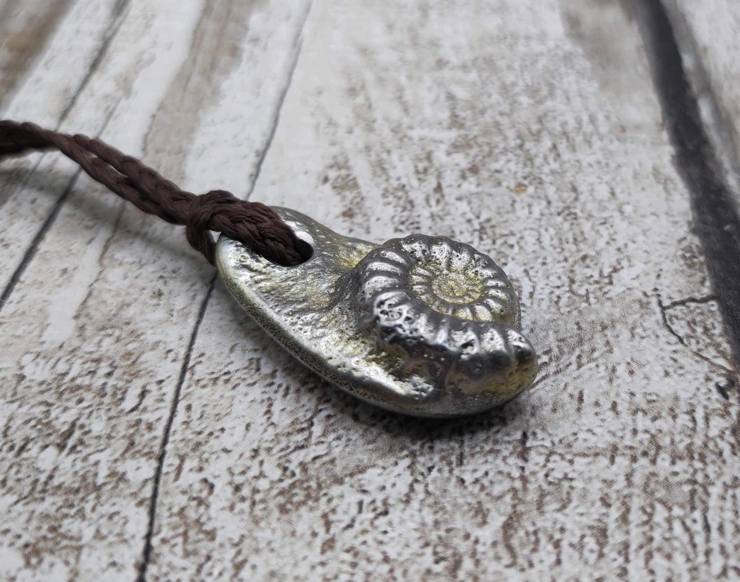 Pewter cast metal ammonite pendant.