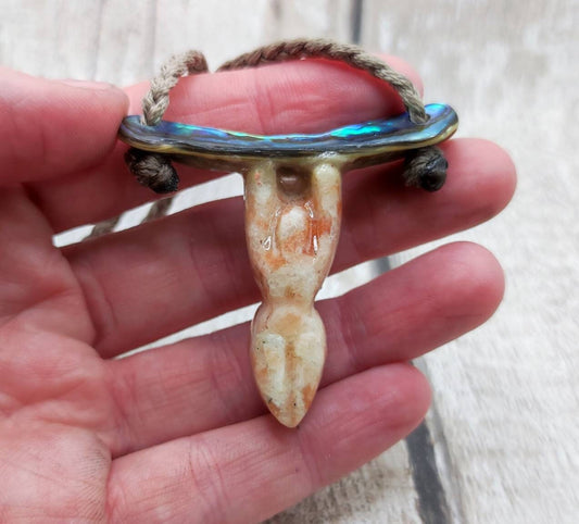 Sunstone goddess stone pendant on rainbow Paua.