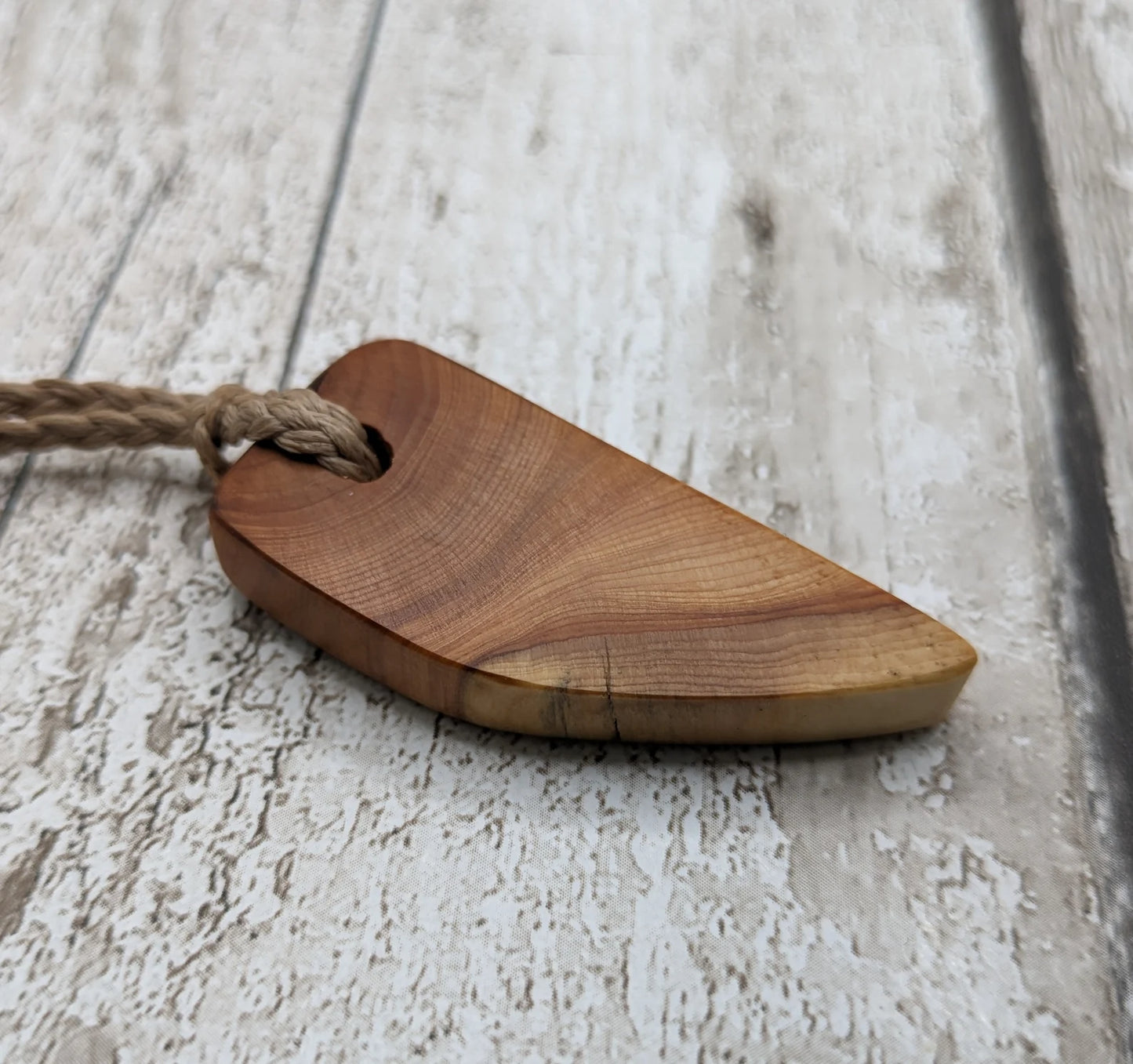 Yew wood slice pendant.