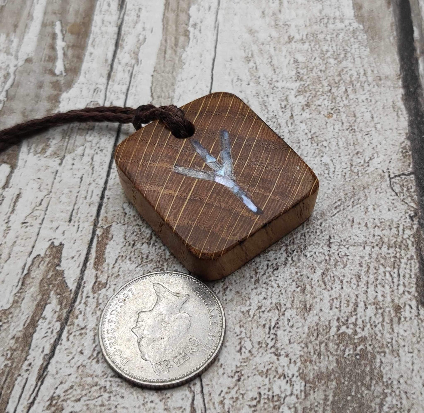 Algiz oak wood rune Christmas decoration with mussel shell inlay.