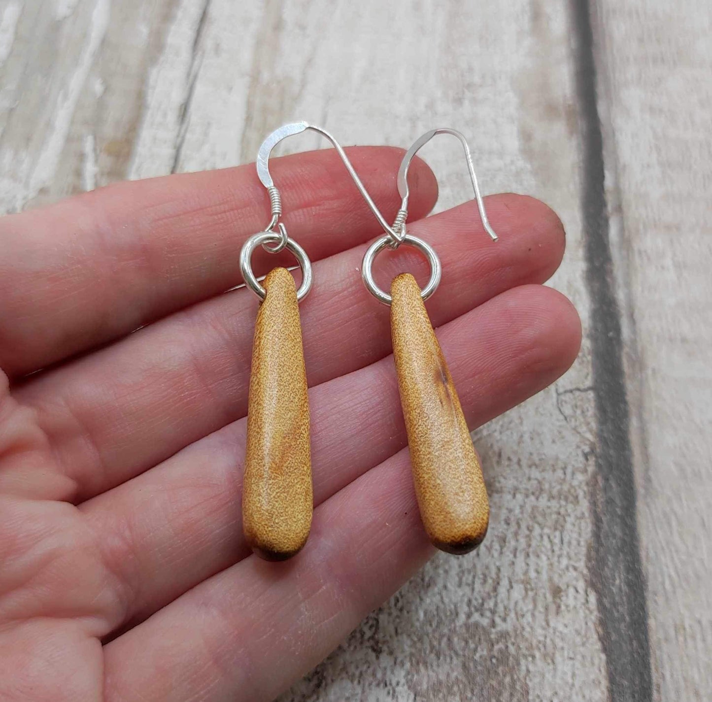 New Zealand swamp kauri wood, roimata earrings, with serpentine Pounamu inlay.