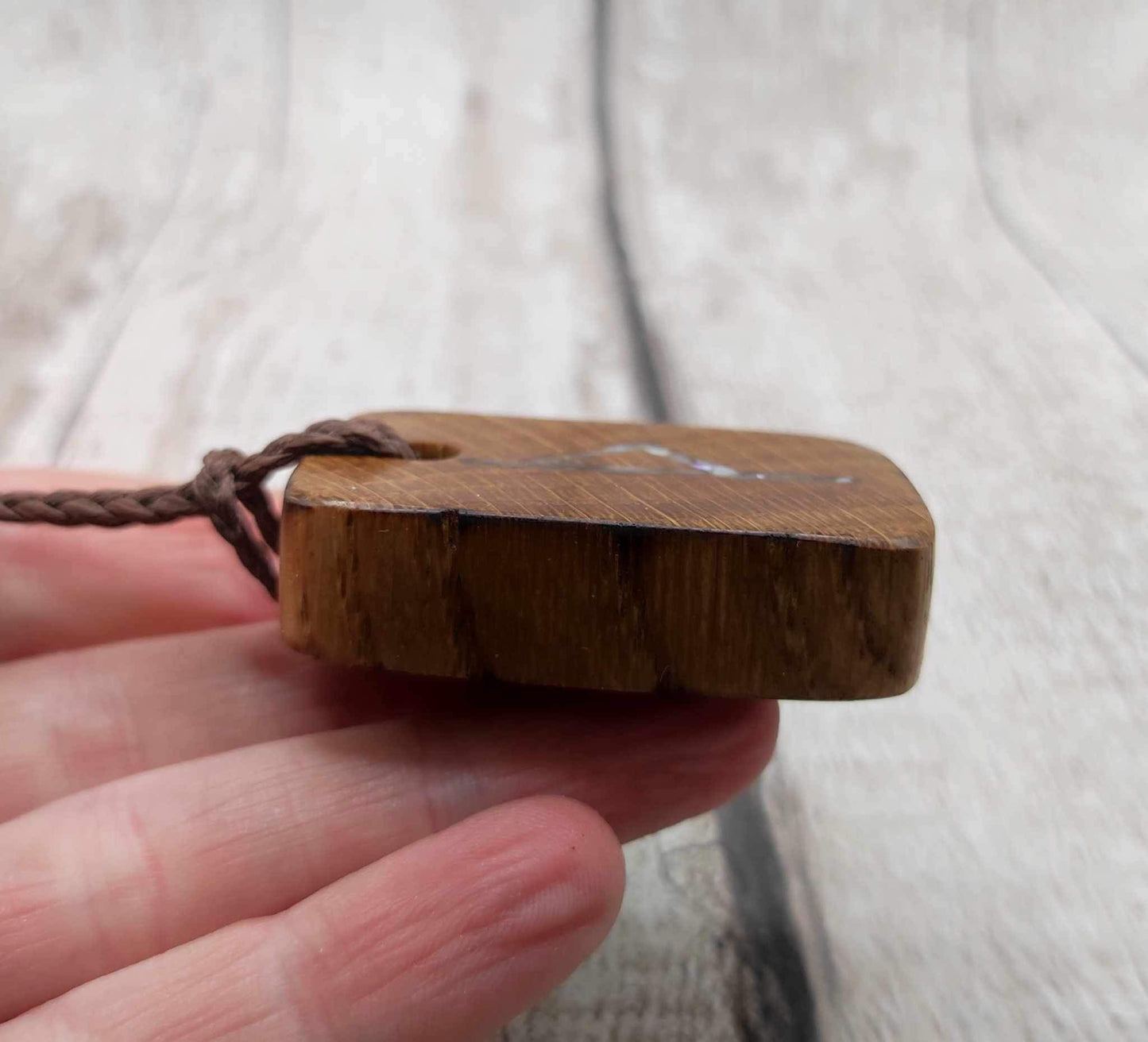 Wunjo oak wood rune pendant with mussel shell inlay.