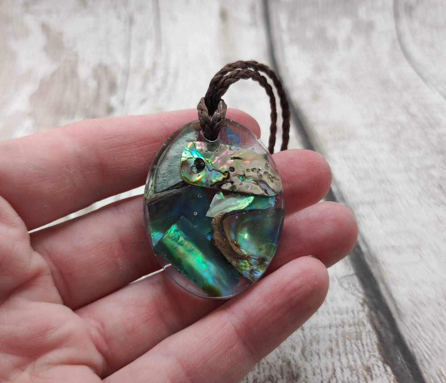 New Zealand Pāua in UV resin pendant.